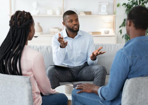 Family Psychotherapy. African American Couple Listening To Counselor's Advices During Therapy